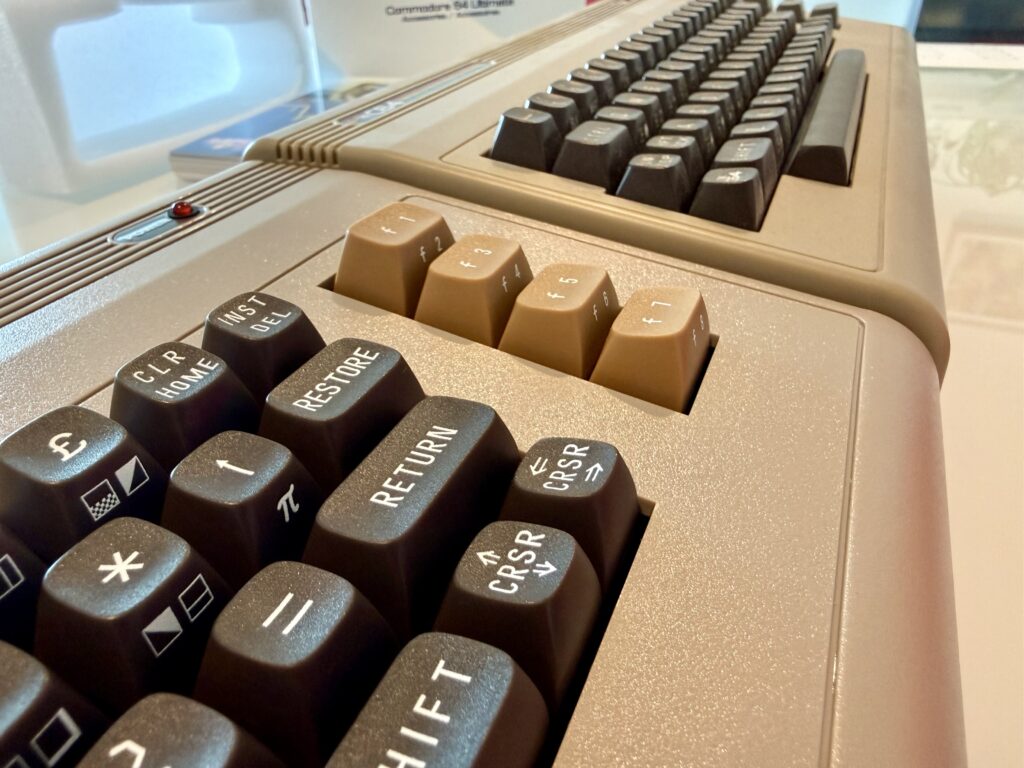The C64U in front, side by side with TheC64 Maxi